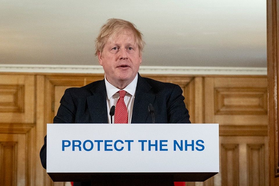 Image of boris johnson at a podium which reads protect the NHS